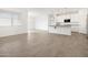 Open concept living space featuring tile flooring flowing into the island kitchen at 35445 N Seedling St, San Tan Valley, AZ 85144