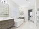 Spa-like bathroom with double sinks, soaking tub, and shower, and access to the laundry room at 4571 S Pinaleno W Dr, Chandler, AZ 85249