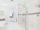 Bright bathroom featuring a glass-enclosed shower, modern fixtures, and easy access to laundry at 4571 S Pinaleno W Dr, Chandler, AZ 85249