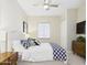Cozy bedroom featuring a queen bed, ceiling fan, and wood dresser at 4571 S Pinaleno W Dr, Chandler, AZ 85249
