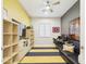 Bright bedroom featuring a ceiling fan, striped rug, and built-in shelves at 4571 S Pinaleno W Dr, Chandler, AZ 85249