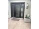 Modern entryway with a decorative glass door, stylish light fixture, and potted succulent at 4571 S Pinaleno W Dr, Chandler, AZ 85249