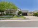 Stunning single-story home with lush landscaping, modern design, and a spacious driveway at 4571 S Pinaleno W Dr, Chandler, AZ 85249