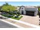 This home features a circular driveway, pristine landscaping and an attached garage at 4571 S Pinaleno W Dr, Chandler, AZ 85249