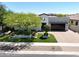 A stylish home showcasing a lush front yard with manicured landscaping and a modern facade at 4571 S Pinaleno W Dr, Chandler, AZ 85249