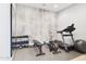 Home gym with work out equipment, a mirror and cool gray accent wall at 4571 S Pinaleno W Dr, Chandler, AZ 85249