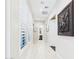 Bright hallway featuring an elegant elephant art piece and light wood flooring at 4571 S Pinaleno W Dr, Chandler, AZ 85249