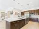 Bright kitchen featuring a large island with sink, stainless steel appliances, and custom cabinetry at 4571 S Pinaleno W Dr, Chandler, AZ 85249