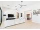 Contemporary living room offers light wood floors, modern ceiling fans, and neutral decor at 4571 S Pinaleno W Dr, Chandler, AZ 85249