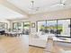 Open-concept living space featuring light wood flooring and glass doors leading to the outdoor patio at 4571 S Pinaleno W Dr, Chandler, AZ 85249