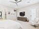 Serene main bedroom featuring modern ceiling fan, patio access, and ensuite bathroom entrance at 4571 S Pinaleno W Dr, Chandler, AZ 85249