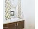 Stylish powder room featuring decorative mosaic tile accent wall and modern vanity at 4571 S Pinaleno W Dr, Chandler, AZ 85249
