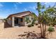 This backyard features desert landscaping and a covered patio, perfect for relaxing in the shade at 5750 S 250Th Dr, Buckeye, AZ 85326