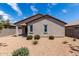 This backyard features desert landscaping, partial patio cover, and exterior walls at 5750 S 250Th Dr, Buckeye, AZ 85326