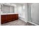 Bathroom featuring a double vanity, soaking tub and glass shower stall at 5750 S 250Th Dr, Buckeye, AZ 85326