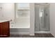 Bright bathroom featuring a soaking tub, separate shower and gray wood-look floors at 5750 S 250Th Dr, Buckeye, AZ 85326