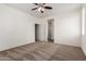 Spacious bedroom with a ceiling fan, carpet flooring, and ensuite bathroom access at 5750 S 250Th Dr, Buckeye, AZ 85326