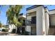 A clean two-story condo with a balcony, green tree, black railings, and a staircase at 740 W Elm St # 264, Phoenix, AZ 85013