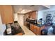 Galley kitchen with black granite countertops, stainless steel appliances, and tiled floors at 740 W Elm St # 264, Phoenix, AZ 85013