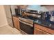 Close up of kitchen with granite counters, stainless steel oven, and overhead microwave at 740 W Elm St # 264, Phoenix, AZ 85013
