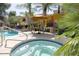 Community hot tub next to the pool with outdoor furniture at 11375 E Sahuaro Dr # 1107, Scottsdale, AZ 85259