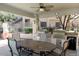 Community outdoor kitchen with table, chairs, ceiling fan and built-in BBQ grills at 11375 E Sahuaro Dr # 1107, Scottsdale, AZ 85259