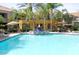 Community pool with outdoor furniture and lush landscaping at 11375 E Sahuaro Dr # 1107, Scottsdale, AZ 85259