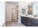 Bathroom featuring double sinks and an open walk-in closet at 12474 W Glenn Ct, Glendale, AZ 85307