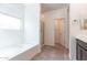 Bright bathroom featuring a soaking tub, shower, and tiled floors at 12474 W Glenn Ct, Glendale, AZ 85307