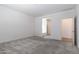 Carpeted bedroom with neutral color palette offering an open layout and access to the bathroom at 12474 W Glenn Ct, Glendale, AZ 85307