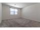Bedroom with carpet, neutral paint, and window for natural light at 12474 W Glenn Ct, Glendale, AZ 85307