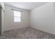 Simple bedroom with carpet flooring, a window, and a closet at 12474 W Glenn Ct, Glendale, AZ 85307