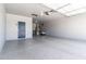 Spacious garage with epoxy flooring, overhead lighting, and ample room for parking and storage at 12474 W Glenn Ct, Glendale, AZ 85307