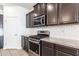 Beautiful kitchen features stainless steel appliances, modern cabinetry, granite counters and subway tile backsplash at 12474 W Glenn Ct, Glendale, AZ 85307