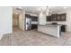 Modern kitchen with stainless steel appliances and dark wood cabinets at 12474 W Glenn Ct, Glendale, AZ 85307