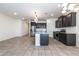 Modern kitchen with stainless steel appliances and a waterfall island at 12474 W Glenn Ct, Glendale, AZ 85307