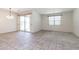 Bright living room with tiled floors, a sliding glass door, and a window at 12474 W Glenn Ct, Glendale, AZ 85307