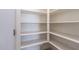 Walk-in pantry featuring ample shelving for food storage and organization at 12474 W Glenn Ct, Glendale, AZ 85307