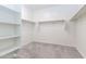 Spacious walk-in closet with carpet and shelving system at 12474 W Glenn Ct, Glendale, AZ 85307
