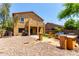 Spacious backyard showcasing a built in outdoor kitchen, desert landscaping, and a covered patio at 12957 W Scotts Dr, El Mirage, AZ 85335