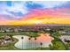Breathtaking aerial view of a lake and golf course community, set against a backdrop of majestic mountains at 14999 W Mulberry Dr, Goodyear, AZ 85395