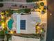 Aerial nighttime view of home with pool, putting green, solar panels, and desert landscaping at 14999 W Mulberry Dr, Goodyear, AZ 85395
