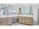 Bright bathroom featuring double sinks, vanity area and neutral tile floor at 14999 W Mulberry Dr, Goodyear, AZ 85395