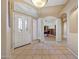 Inviting foyer with decorative glass door, and tile floors, leading to an open office area at 14999 W Mulberry Dr, Goodyear, AZ 85395