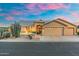 Exterior view of this gorgeous home with a three-car garage, landscaped yard, and a beautiful front door at 14999 W Mulberry Dr, Goodyear, AZ 85395
