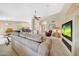 Open-concept living room flows into kitchen, dining area, and media space at 14999 W Mulberry Dr, Goodyear, AZ 85395