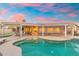Sparkling pool with a covered patio area, lounge chairs, and outdoor seating for relaxation and entertainment at 14999 W Mulberry Dr, Goodyear, AZ 85395