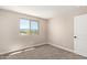 Well-lit bedroom with plush carpet, mountain view window, and neutral color scheme at 15622 S 181St Dr, Goodyear, AZ 85338