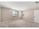 Spacious bedroom with plush neutral carpet, bright natural light, and white door at 15622 S 181St Dr, Goodyear, AZ 85338