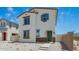 Two-story home with a white exterior, complemented by brown trim, green door and landscaping on a sunny day at 15622 S 181St Dr, Goodyear, AZ 85338